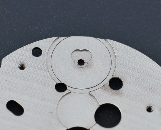 The rear of the auxiliary plate from a watch movement