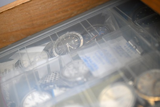 A photograph of a box of vintage watches