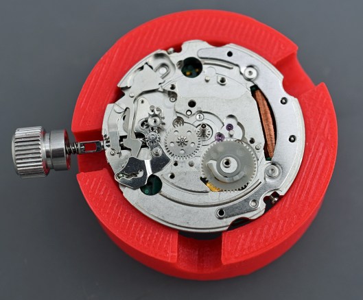 The calendar side of the movement showing the plastic day/date driving wheel