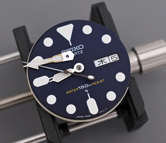 Seiko 7548 dial with hands removed and resting on the dial
